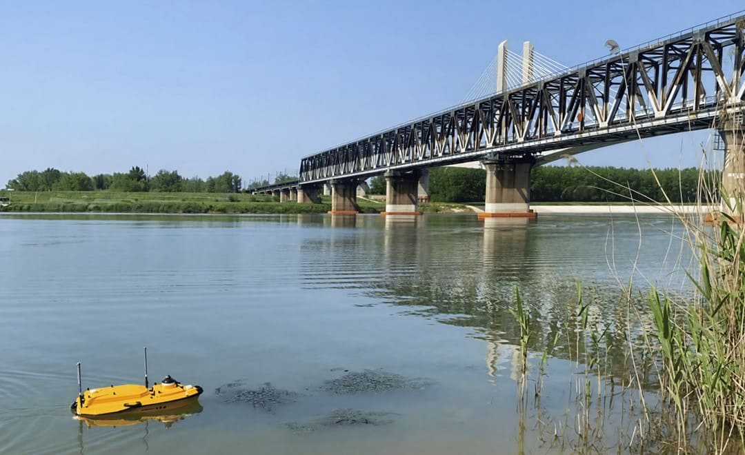 Apache 4 USV collecting bathymetric data near bridge piers.